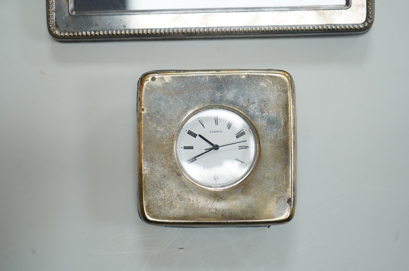 Two modern silver mounted photograph frames, largest 20.4cm by 15.2cm, an Italian 925 mounted photograph frame and a modern silver mounted desk timepiece.
